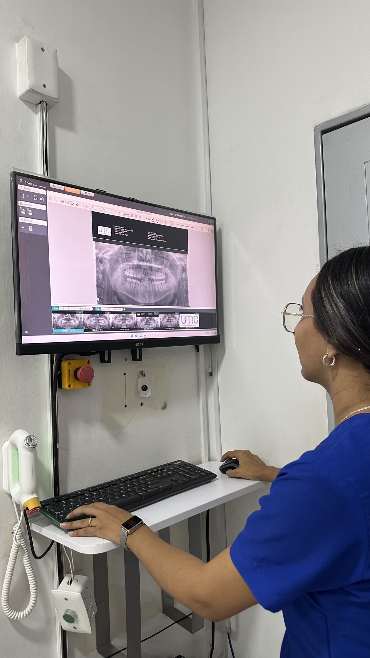 Profesional revisando una radiografía panorámica dental en la estación de visualización.